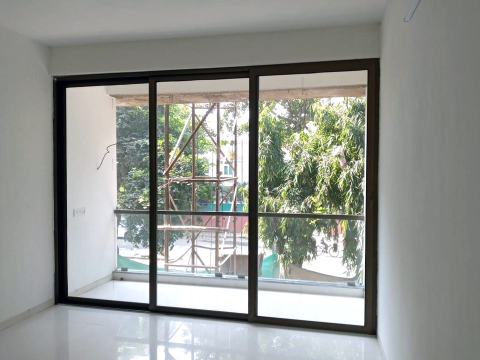 An aluminium sliding window with fixed glazing, surveyed and fabricated to the built opening.