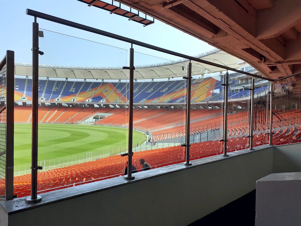 Glass spectator railing along an upper stadium tier